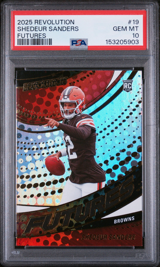 PSA-graded trading card in clear case showing Shedeur Sanders in red Browns uniform throwing football against red and cyan geometric background.