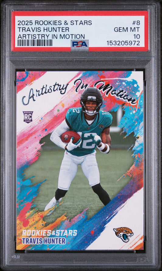 PSA-graded trading card in plastic holder displaying Travis Hunter in teal Jaguars uniform against colorful pink and blue artistic background with "Artistry in Motion" text.