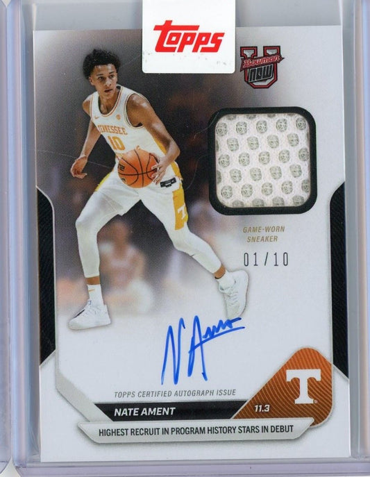 Front of card showing Nate Ament in white Tennessee jersey dribbling basketball, with game-worn sneaker swatch and blue autograph, numbered 01/10.