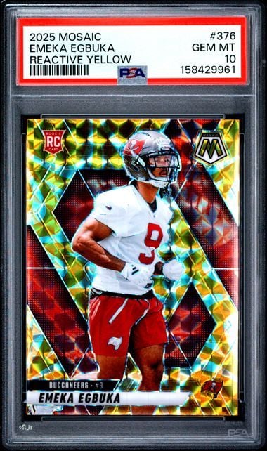 PSA-graded football card displaying Emeka Egbuka in white jersey against yellow reactive foil background with red borders.