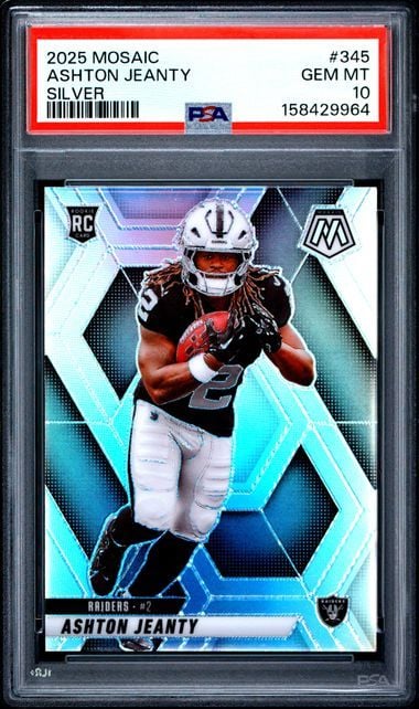 PSA-graded rookie card in protective case showing Ashton Jeanty in Raiders uniform against cyan geometric background design.