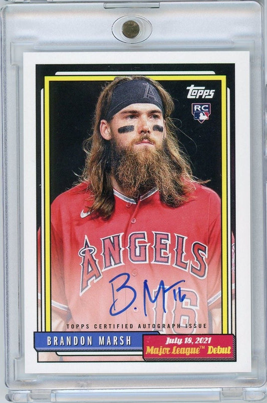 Signed 2022 Topps Archives Baseball card of Brandon Marsh in red Angels uniform with headband, displayed in protective plastic case.