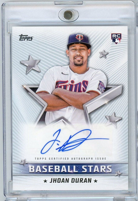 Signed rookie baseball card of Jhoan Duran in Minnesota Twins uniform, featuring blue autograph and star design elements on clear plastic holder.
