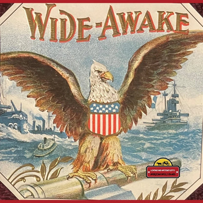 Bald eagle on a cannon with stars and stripes in this 1910s antique cigar label