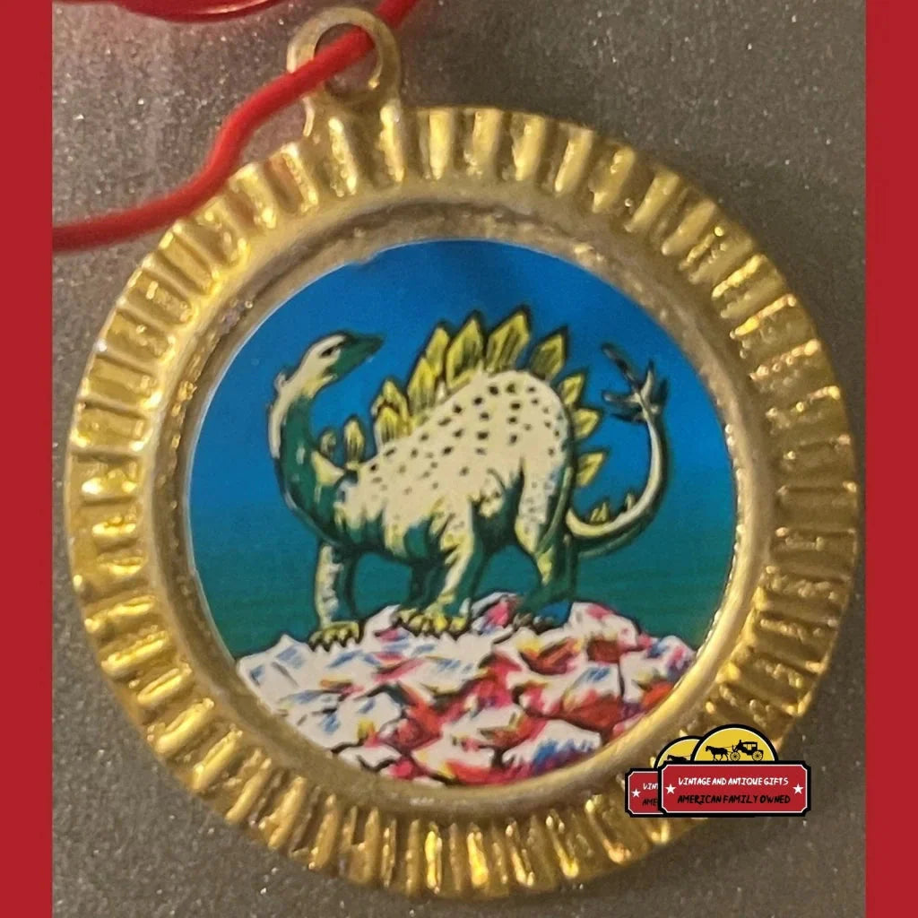 Gold-rimmed medallion with a cartoon stegosaurus on blue, perfect for vintage tin dinosaur lovers