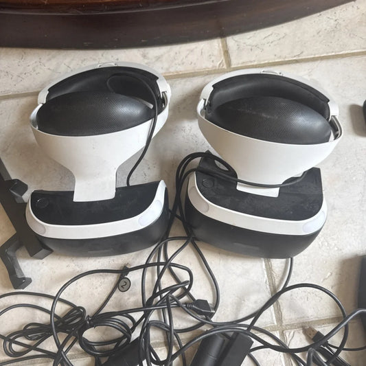 Two PlayStation VR headsets in white and black with textured padding