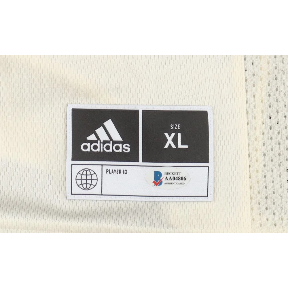 Adidas athletic jersey tag on Kansas Jayhawks team-signed jersey with Dajuan Harris