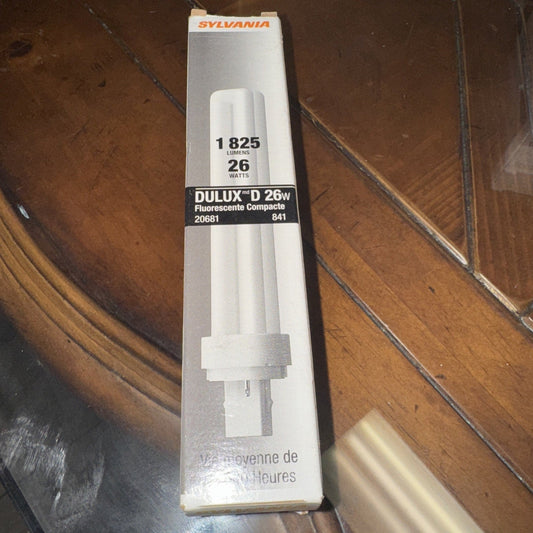 Sylvania Dulux D 26W fluorescent compact bulb packaging displayed flat on wooden surface, showing front label with specifications and product image.