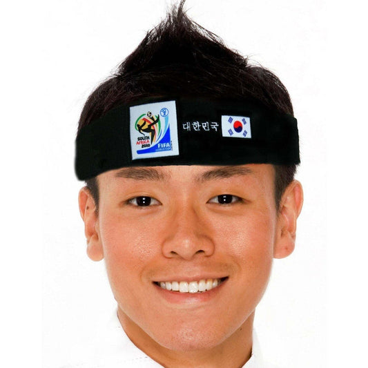 Man wearing black fabric headband with South Africa 2010 FIFA World Cup logo, Korean text, and South Korean flag on white background.