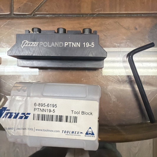 Gray Poland PTNN 19-5 lathe tool block with packaging label showing part number 6-895-6195 and hex wrench, top view.