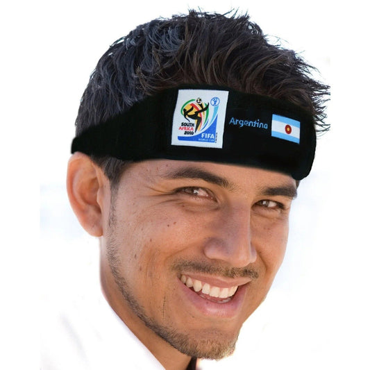 Man wearing black headband with 2010 FIFA World Cup South Africa logo and Argentina flag, smiling at camera.