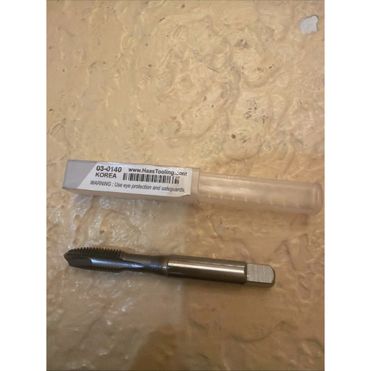 Haas Tooling 03-0140 thread tap tool displayed on textured beige surface with product label and packaging visible above the black and silver metal tool.