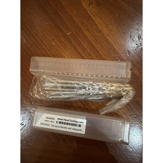 Overhead view of packaged replacement blade set on wood surface showing clear plastic wrapper containing metal blades and labeled box with product number 03-0312.