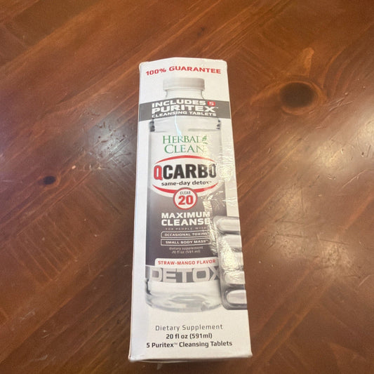 Sealed white and black Herbal Clean QCarbo Clear 20 detox bottle on wooden floor, front label visible.