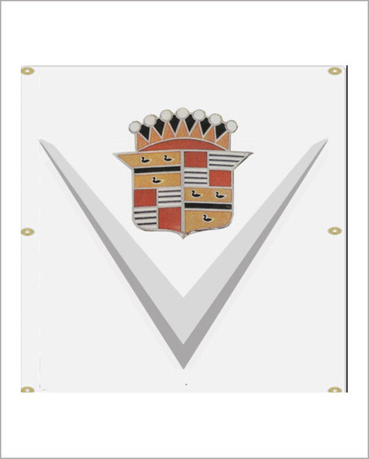 White vinyl banner, straight-on view, with a grey V chevron and a red, gold and black Cadillac crest, with grommets along its edges.