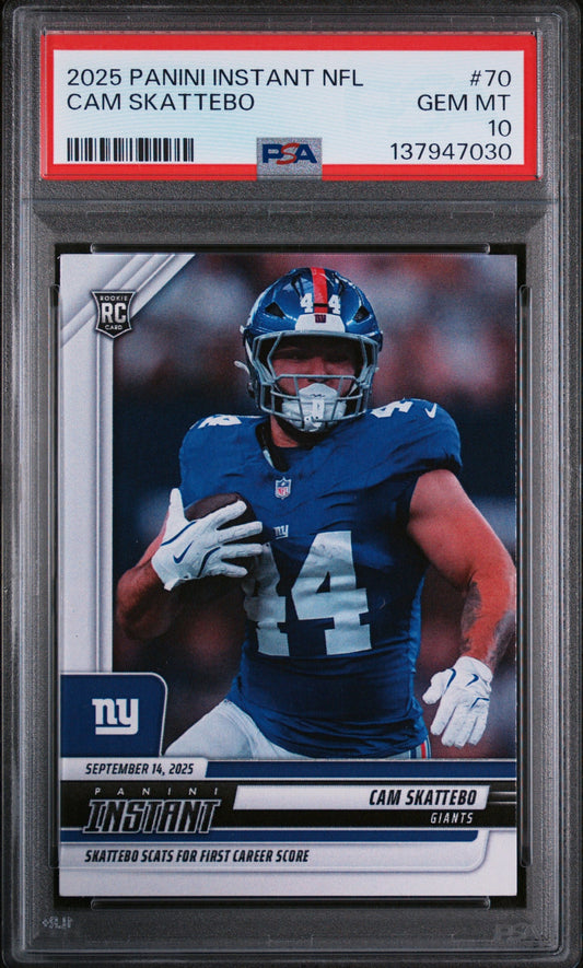 PSA-graded rookie card in clear plastic holder showing Cam Skattebo in New York Giants blue uniform with white gloves and red label identifying card number, player name, and gem mint 10 grade.