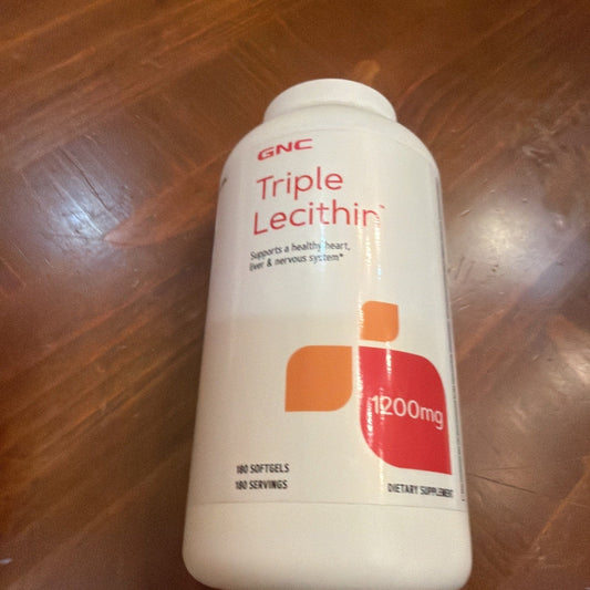 White plastic bottle of GNC Triple Lecithin 1200mg supplement with orange and red label on wooden surface.