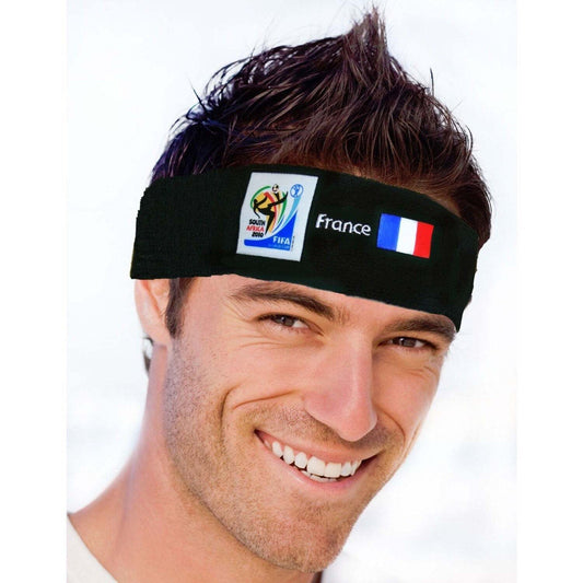Man wearing black headband with France flag and 2010 FIFA World Cup South Africa logo, smiling at camera.