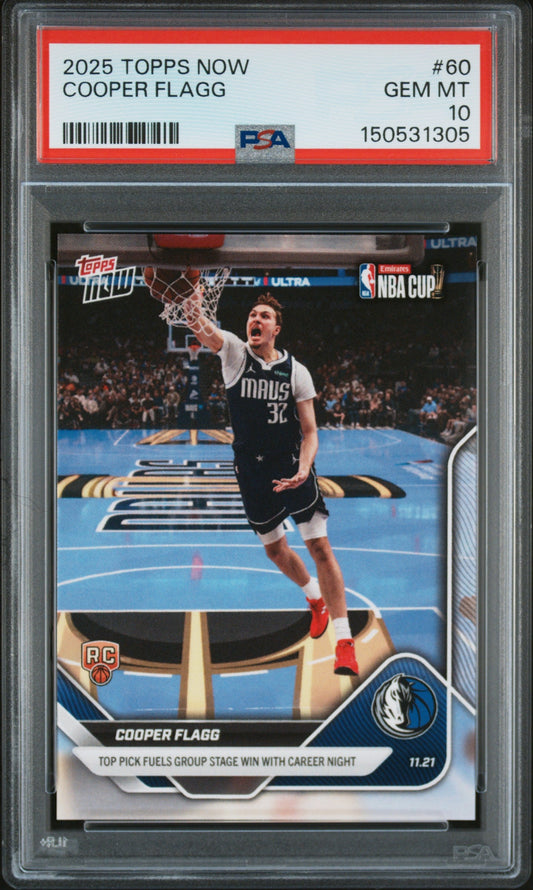 PSA-graded trading card in clear case showing Cooper Flagg in Dallas Mavericks uniform dunking basketball, with red grading label visible at top.