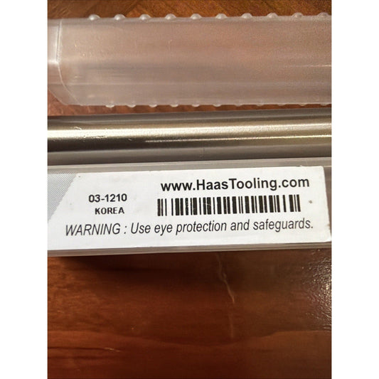 Close-up of product label showing part number 03-1210, Korea origin, website, barcode, and safety warning text on packaging.