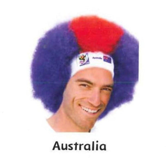 Man wearing purple and red afro wig with white headband displaying Australian flag logo, smiling at camera.