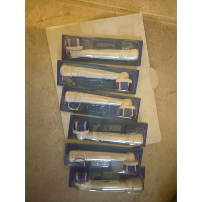 Five Oral-B electric toothbrush heads in blue packaging for replacements
