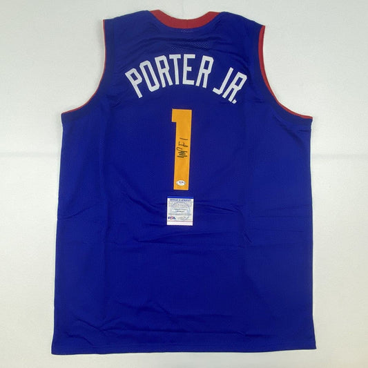 Back view of blue Denver Nuggets basketball jersey number 1 with "PORTER JR" nameplate and visible PSA/DNA authentication certificate.