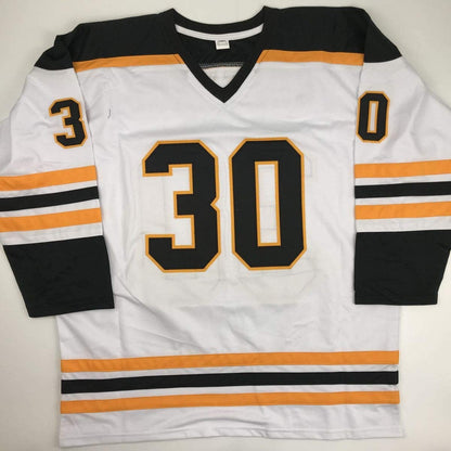 White Boston Bruins hockey jersey number 30 with black and orange trim, displayed flat against gray background.