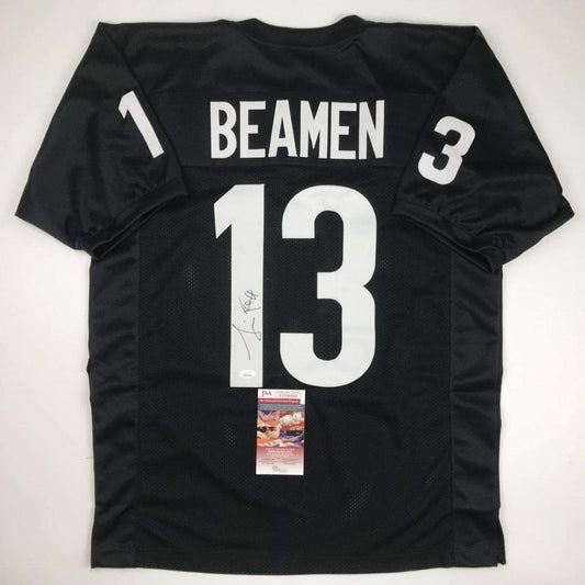 Black football jersey with white "BEAMEN 13" lettering displayed flat against white background, featuring JSA authentication label and autograph on front.