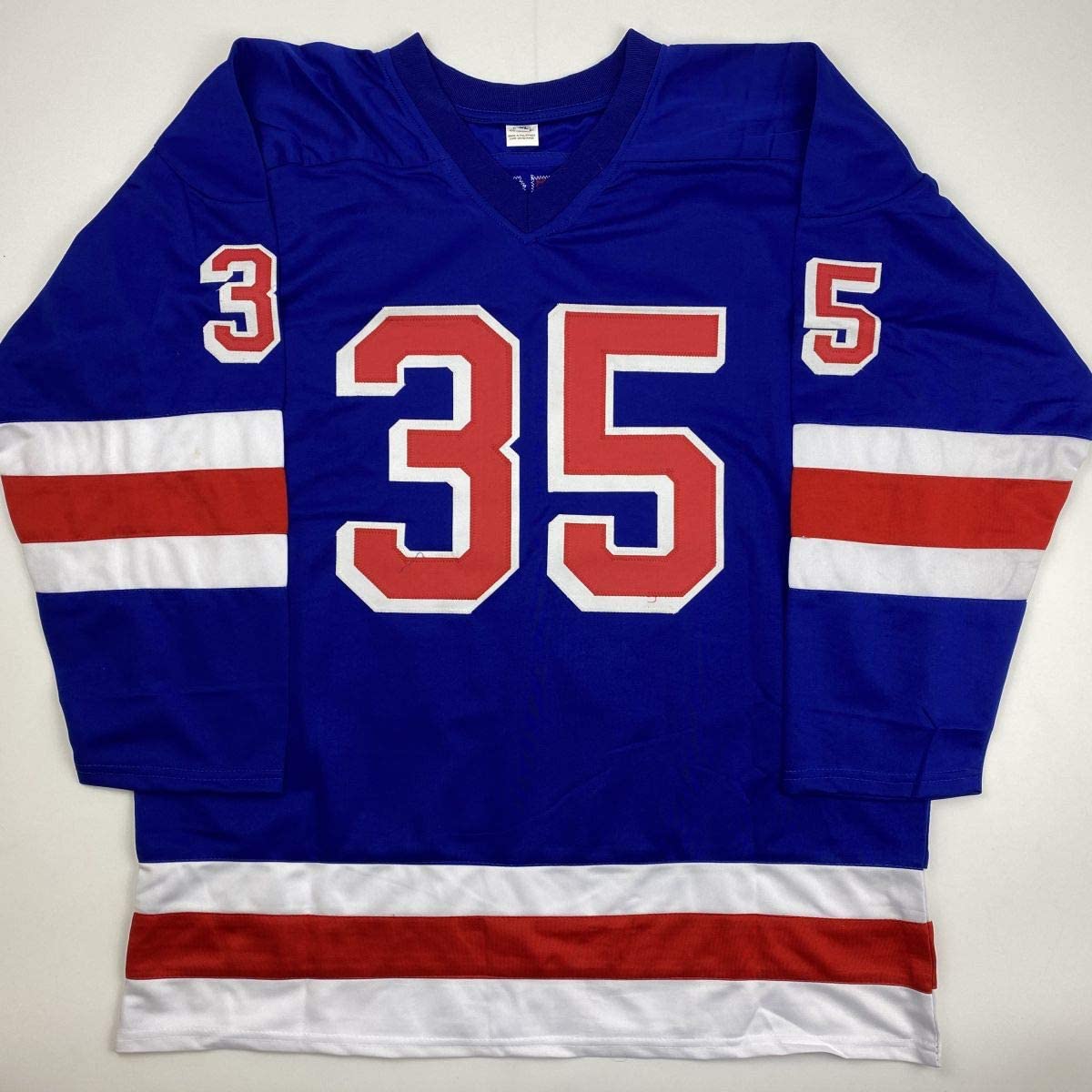 Blue hockey jersey with red and white horizontal stripes, number 35 in red and white on chest, numbers 3 and 5 on shoulders, displayed flat against white background.