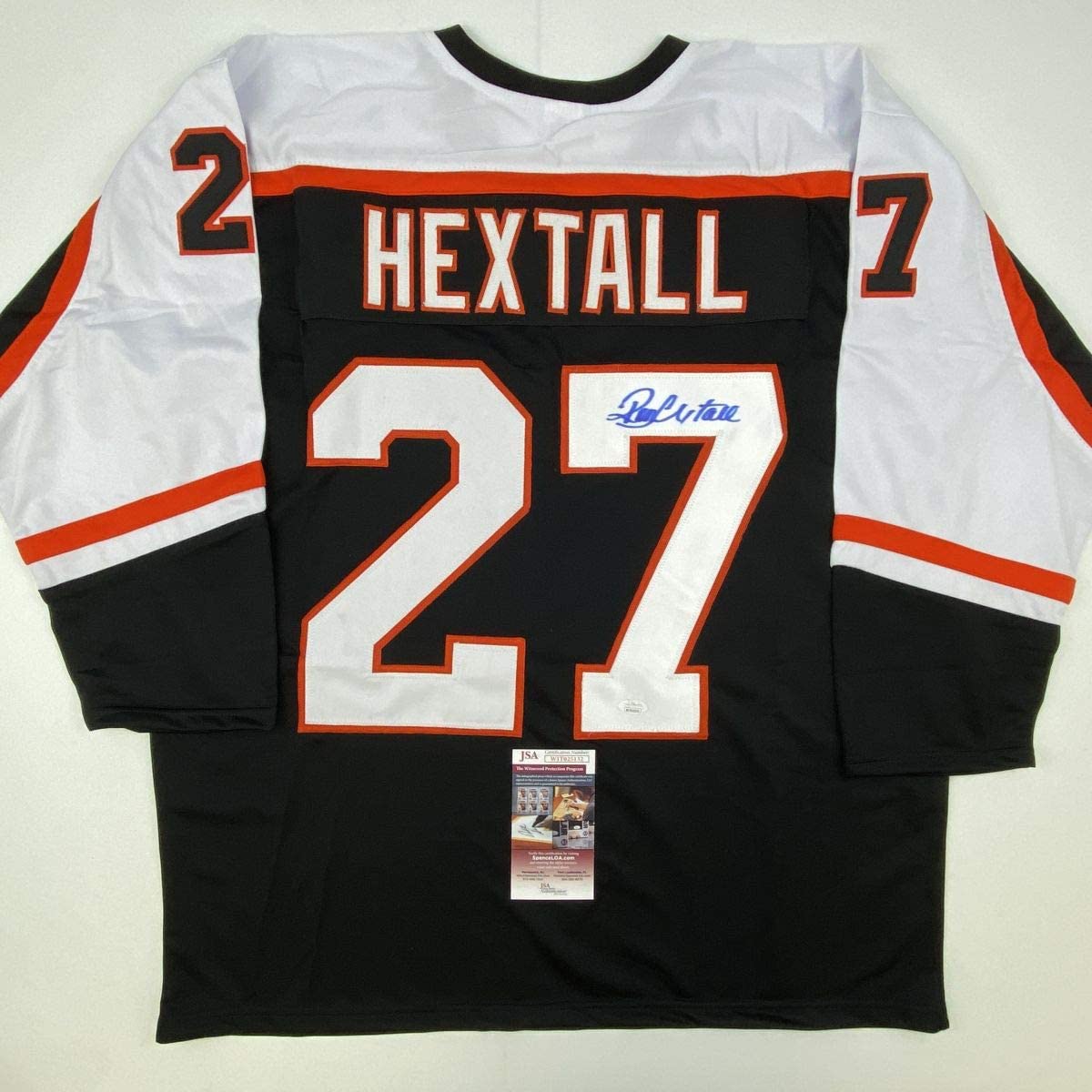 Black Philadelphia Flyers hockey jersey number 27 with "HEXTALL" name and blue autograph, displayed flat with JSA authentication certificate.