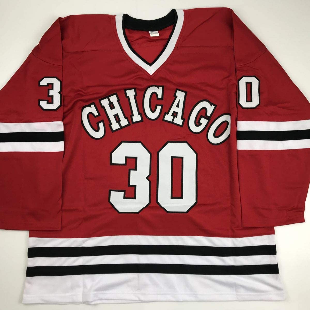 Red Chicago hockey jersey with white "CHICAGO" text and number 30, displayed flat against neutral background.