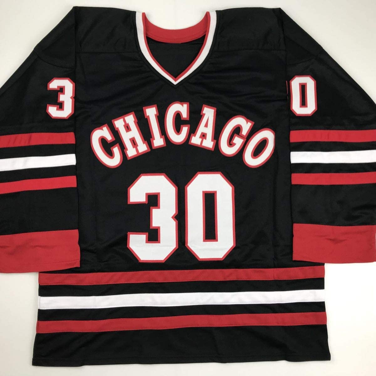 Black Chicago hockey jersey with red and white stripes, displaying "CHICAGO" and number "30" on front, laid flat.