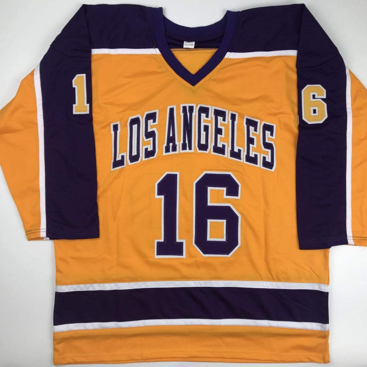 Los Angeles Kings yellow hockey jersey number 16 displayed flat against white background, showing front view with navy blue sleeves and trim.