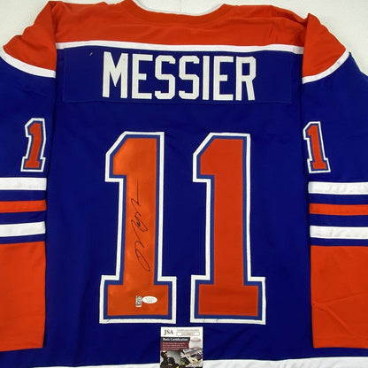 Back view of blue Edmonton Oilers jersey number 11 with "MESSIER" nameplate and signature, displaying JSA authentication certificate.