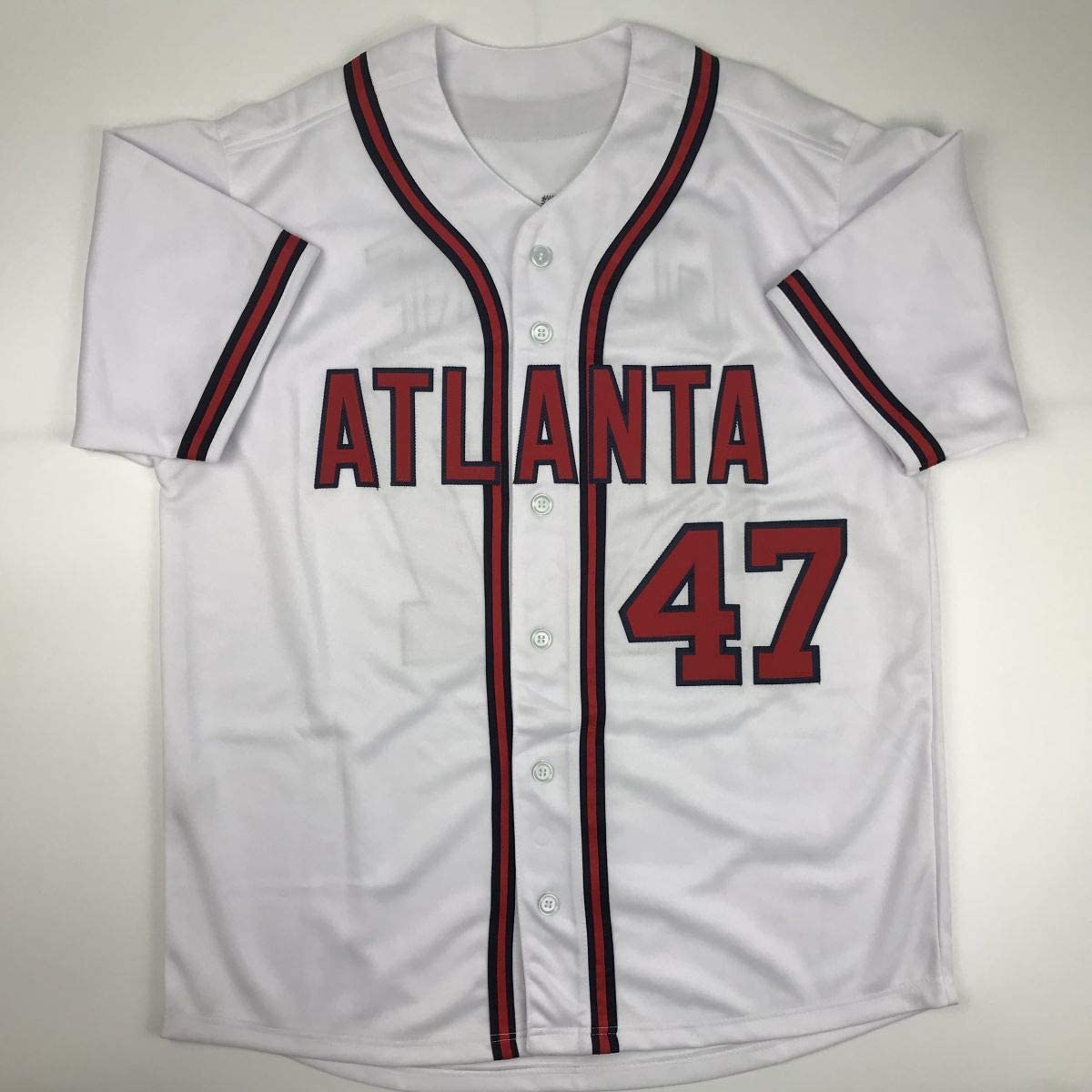 White Atlanta Braves baseball jersey number 47 displayed flat against neutral background, showing front view with red and navy trim.