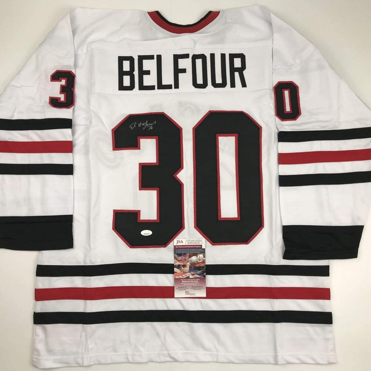 White hockey jersey with red and black horizontal stripes displaying "BELFOUR" and number 30, with JSA authentication certificate visible.