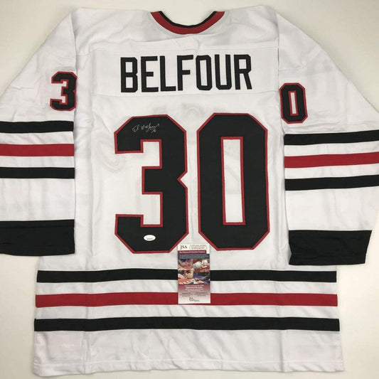 White hockey jersey with red and black horizontal stripes displaying "BELFOUR" and number 30, with JSA authentication certificate visible.