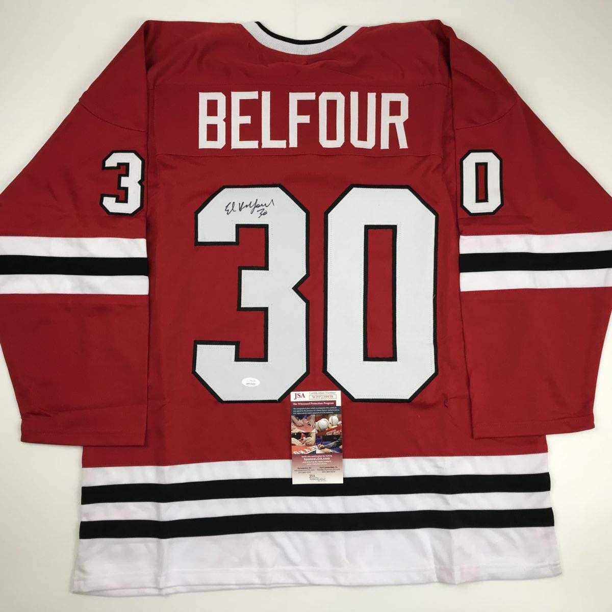 Red Chicago Blackhawks hockey jersey #30 with "BELFOUR" nameplate, signed, displayed flat showing back with JSA authentication certificate.