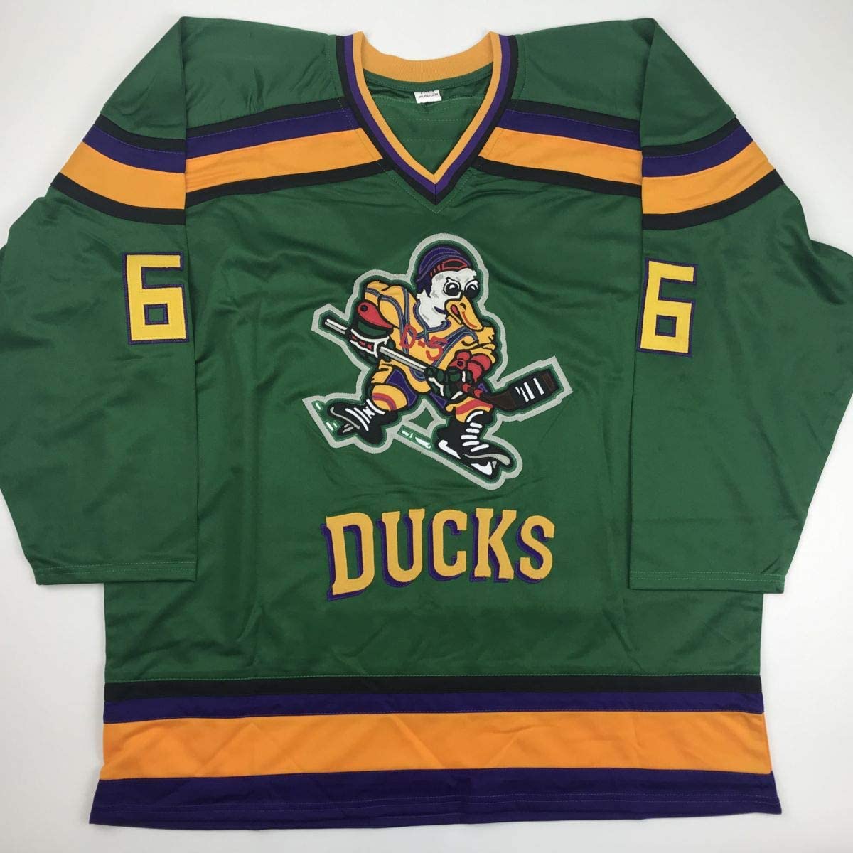 Green Ducks hockey jersey number 6 displayed flat, showing front with embroidered duck logo, yellow and purple striping, and "DUCKS" text.