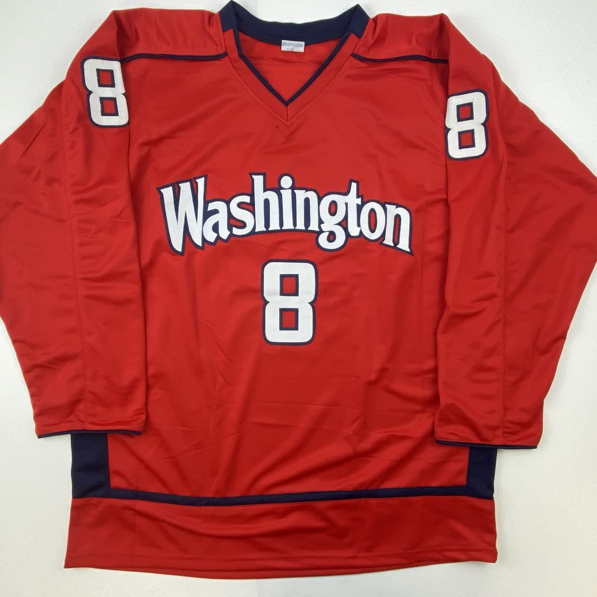 Red Washington hockey jersey number 8 displayed flat on white background, front view showing team name and numerals in white and navy.