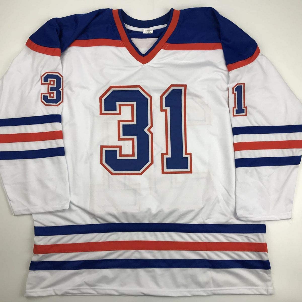 White hockey jersey with navy blue and red stripes, displaying number 31 in center, laid flat on light background.