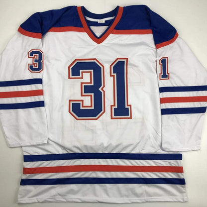 White hockey jersey with navy blue and red stripes, displaying number 31 in center, laid flat on light background.