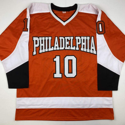 Philadelphia Flyers orange hockey jersey number 10 laid flat, displaying front with white and black trim, showing "PHILADELPHIA" text and jersey number.