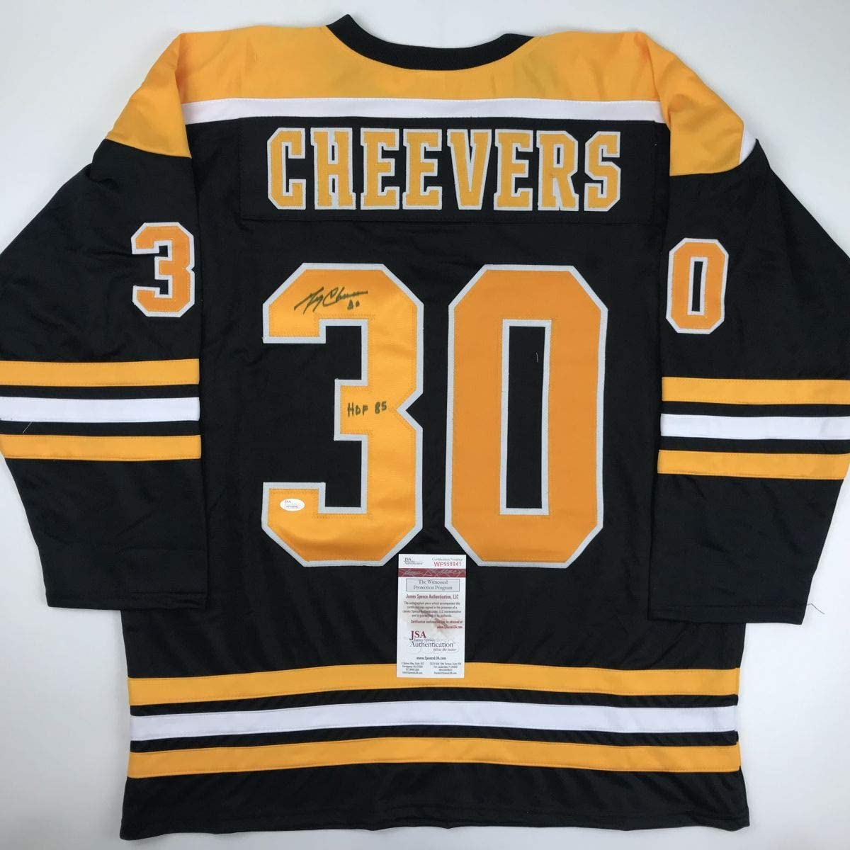 Back view of black and gold Cheevers #30 Bruins hockey jersey with autographed signature and JSA authentication certificate.