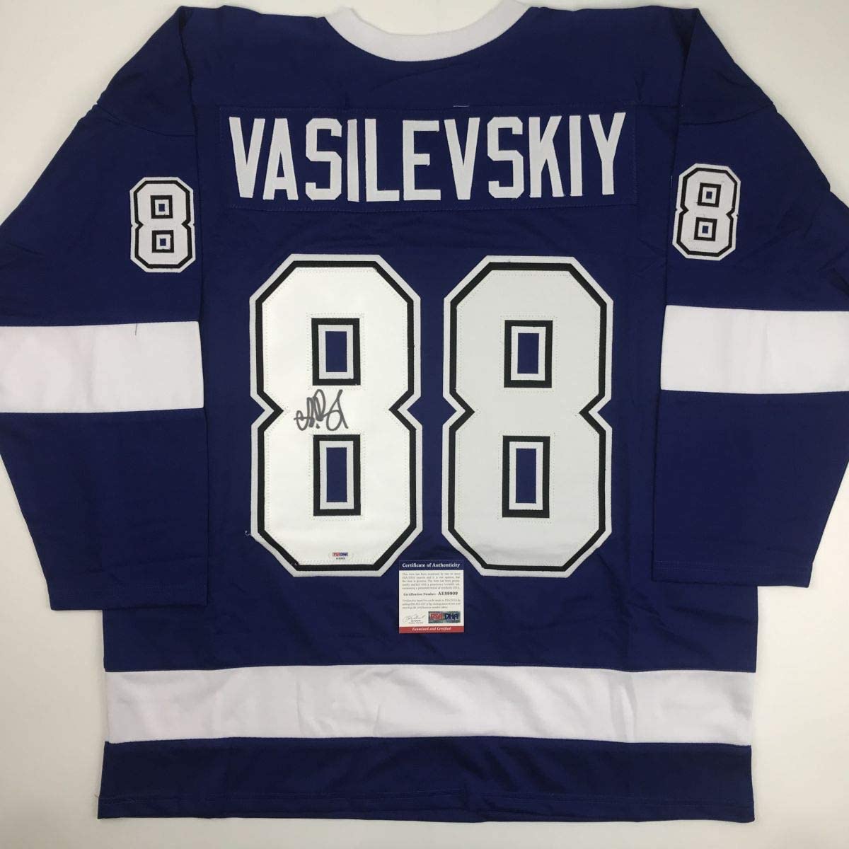 Back view of navy and white hockey jersey with "VASILEVSKIY" and number 88, autographed, PSA/DNA certificate visible.