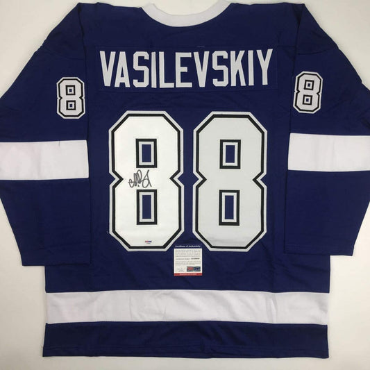 Back view of navy and white hockey jersey with "VASILEVSKIY" and number 88, autographed, PSA/DNA certificate visible.