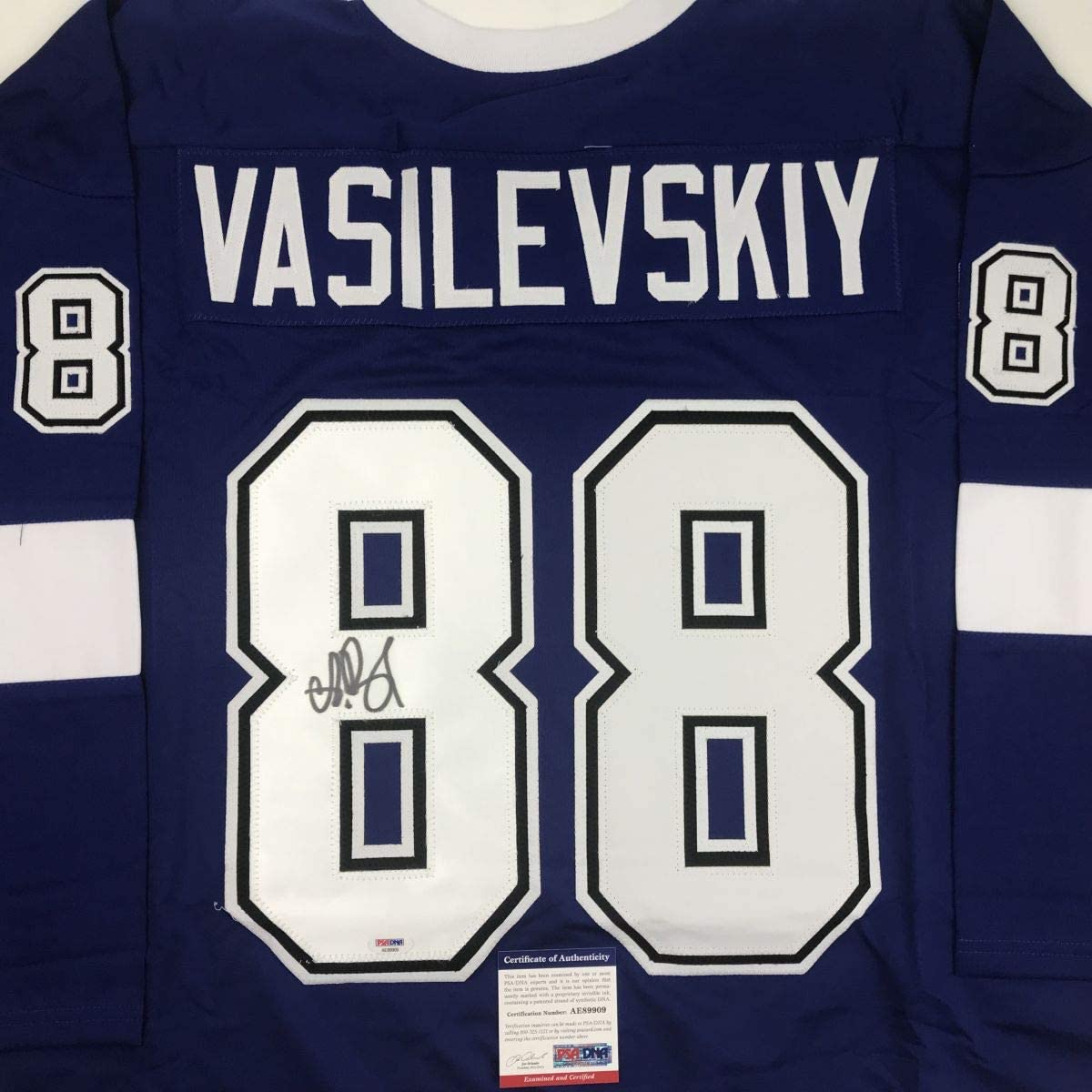 Front view of navy blue hockey jersey with "VASILEVSKIY" and number 88 in white, featuring autograph on left chest number and PSA/DNA authenticity certificate.