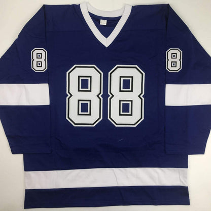 Navy and white hockey jersey with number 88 displayed front and center, laid flat against white background.