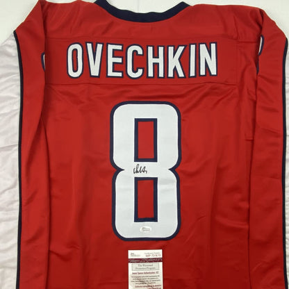 Red Washington hockey jersey with "OVECHKIN" and number 8 displayed on back, signed with JSA authentication certificate visible at bottom.
